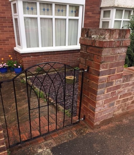 New brick pillars built to take the weight of a metal gate