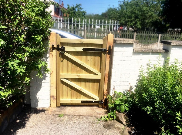 Hook and band hinges fitted to the back face of a wooden garden gate