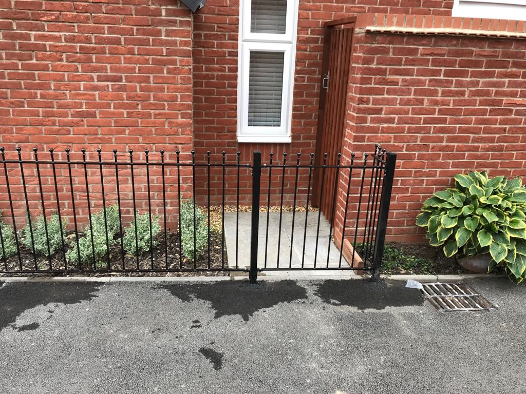 Metal posts set into the ground supporting a fence