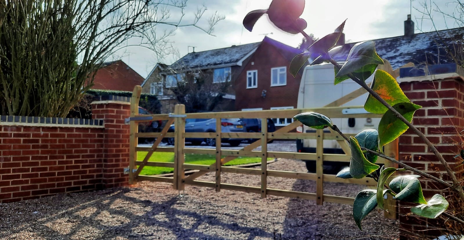 Wooden gates securing a residential driveway