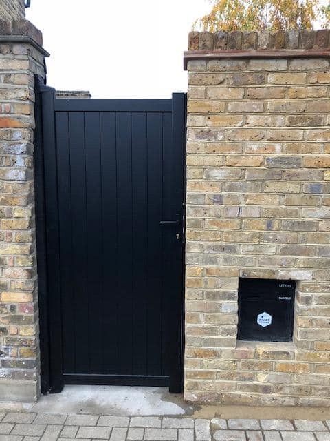 Aluminium vertical infill pedestrian garden gate painted black