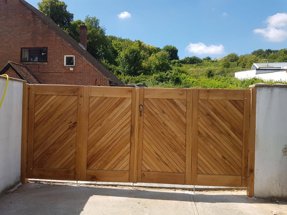 Bi fold oak driveway gates in a bespoke design