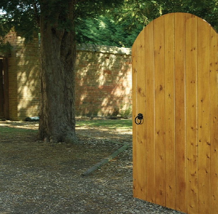 Devon arched wooden garden gate set within a pathway