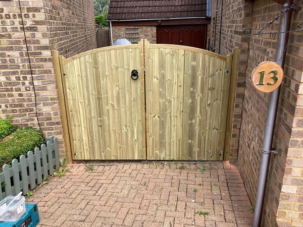 Double wooden estate gates fitted into residential driveway