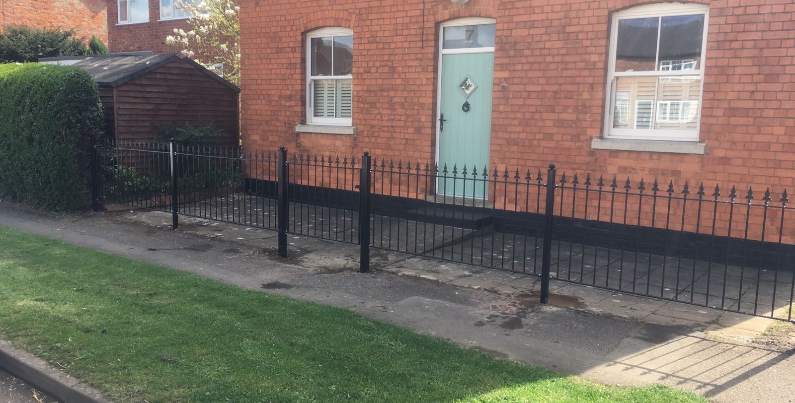 Metal fence fitted to front boundary of a garden