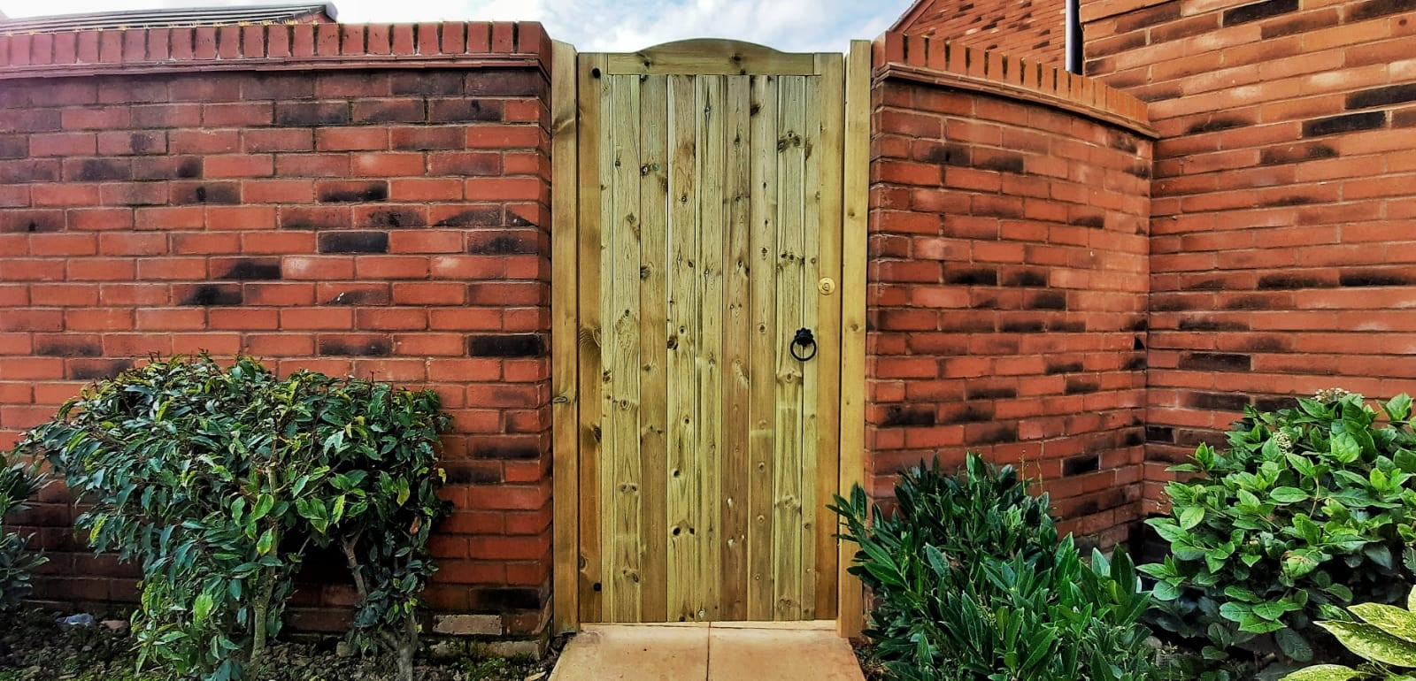 Wooden gate giving security to a boundary wall