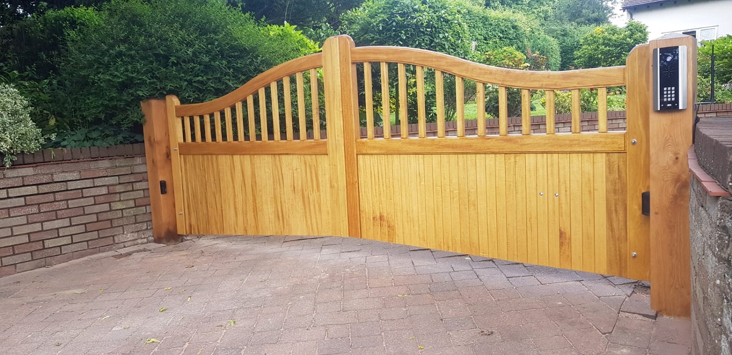 Idigbo driveway gates with arch top, vertical boards and spindles