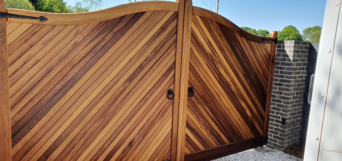 Iroko hardwood driveway  gates with an arched top
