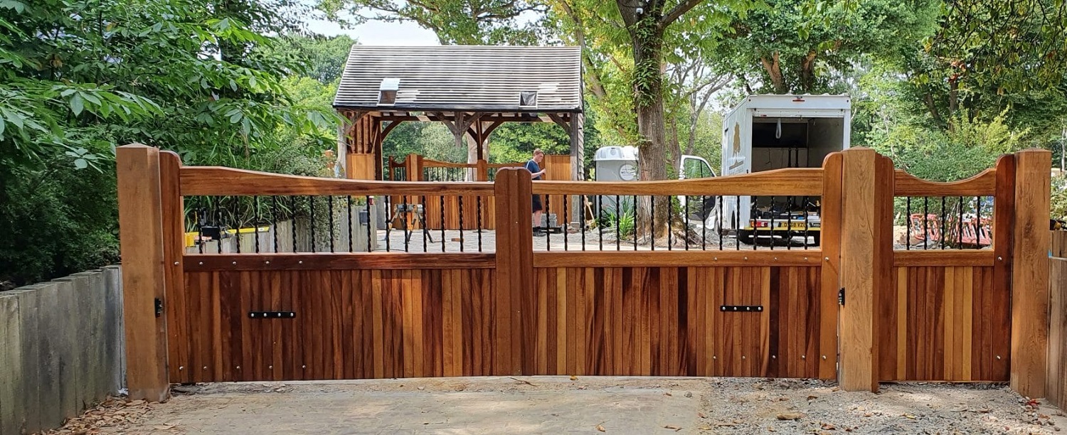 Iroko reverse slope driveway gates and garden gate with metal infil bars