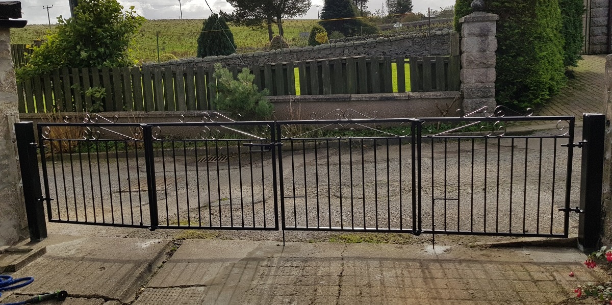 Made to measure Marlborough Bi Folding Double Metal Driveway Gates fitted to wall mounted metal posts