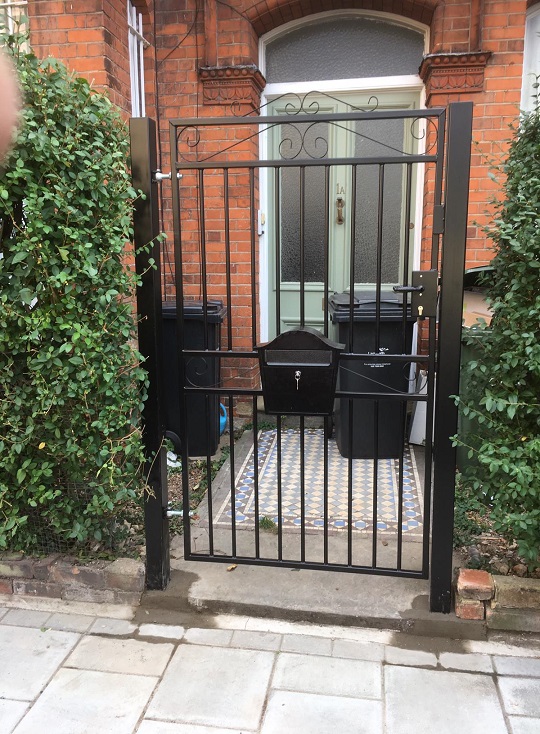 Heavy duty side gate fitted with mortise lock installed using metal posts set into the ground