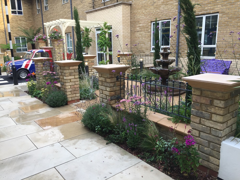 Ball top metal railings mounted between brick pillars