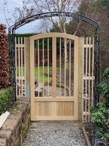 Bespoke oak side gate with arch top and long open pales