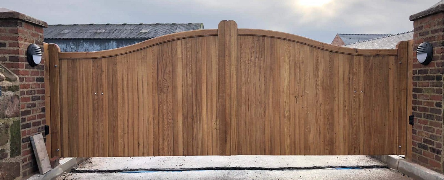Oak swan neck driveway gates with vertical board infill