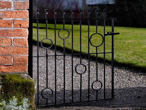 Modern metal garden gate with ball top finials