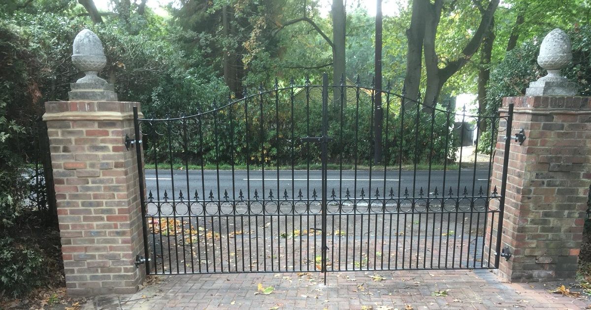 Wrought iron estate gates securing driveway entrance 