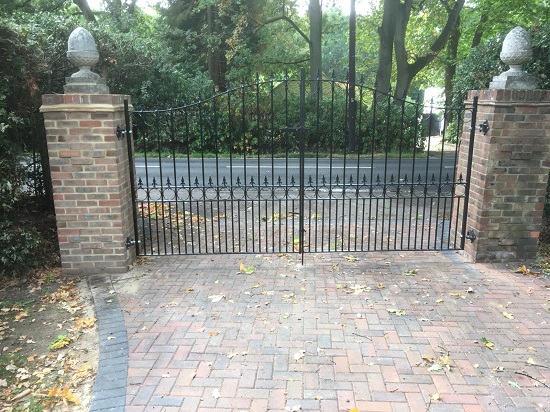 Wrought iron estate gates securing driveway entrance
