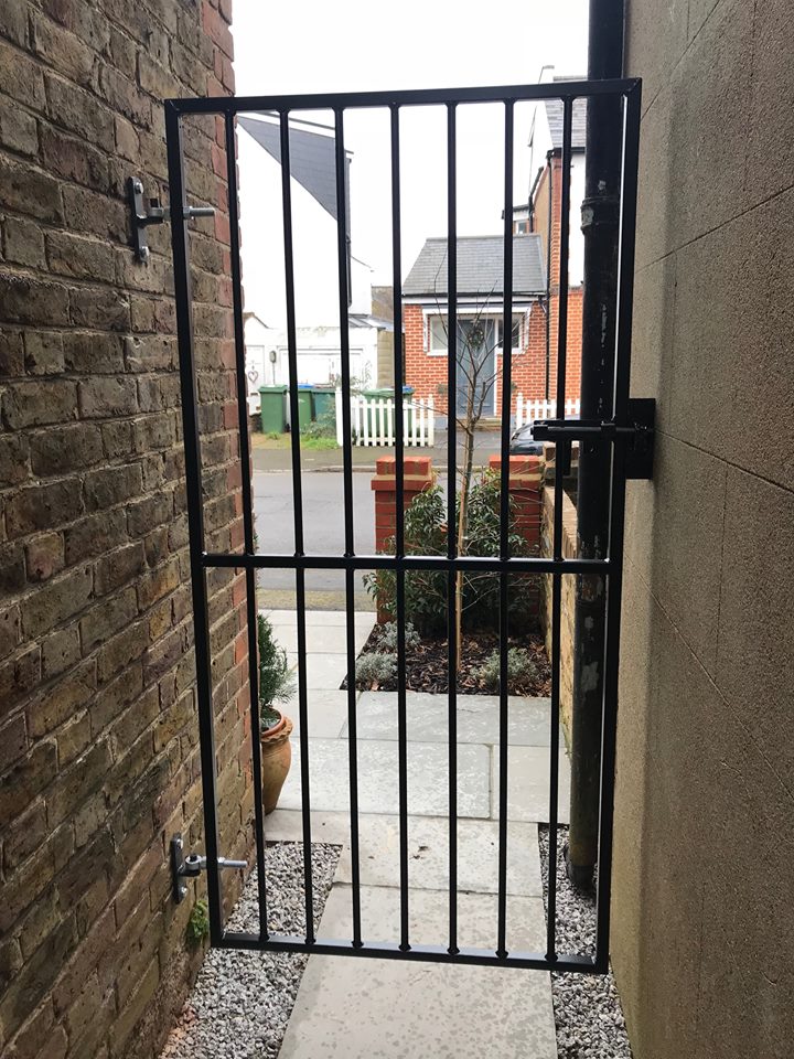 Custom made metal side gate to secure a passageway between houses