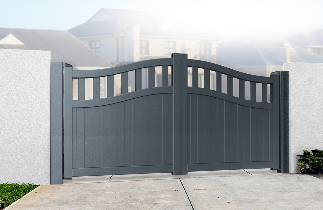 Vertical boarded aluminium driveway gates with an arch top and open pales in anthracite grey