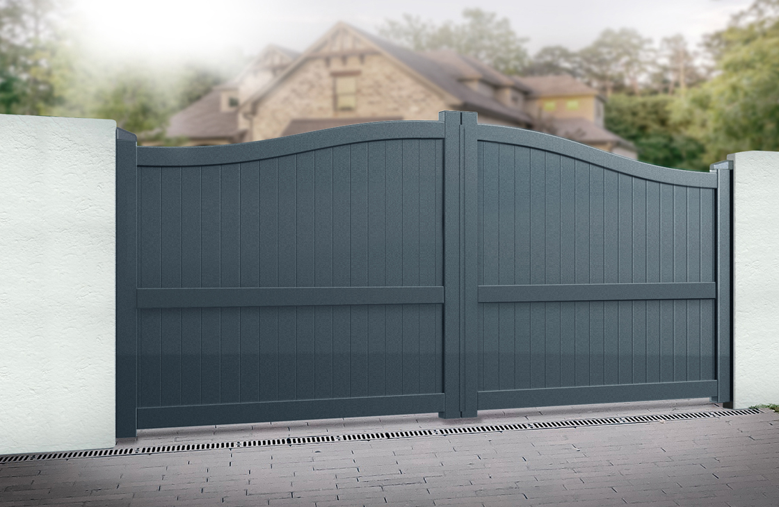Vertical boarded aluminium driveway gates with an arch top in anthracite grey