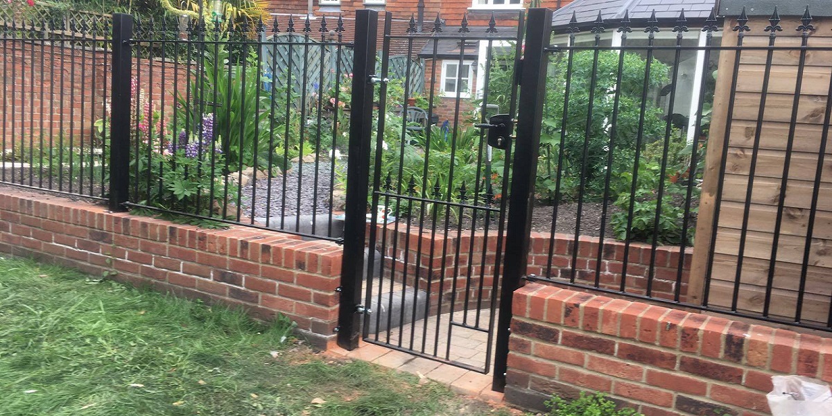 Wrought iron back garden gate with matching metal fence panels